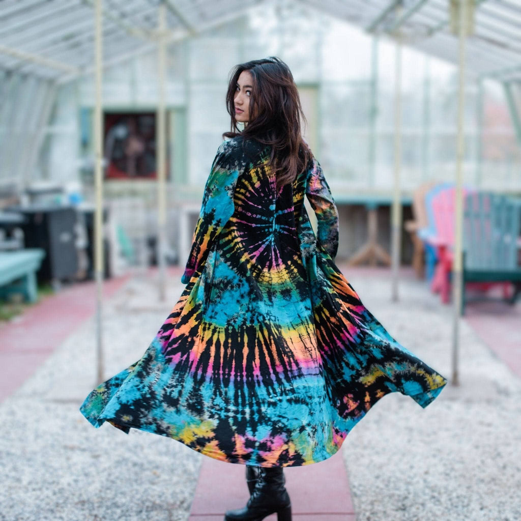 A long, hand-dyed cotton duster featuring a vibrant tie-dye pattern in black, blue, pink, orange, and yellow.