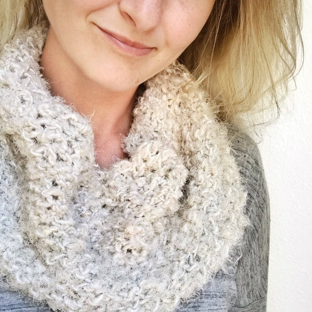 Close-up of a soft, textured handmade cowl knitted from recycled sari silk yarn.