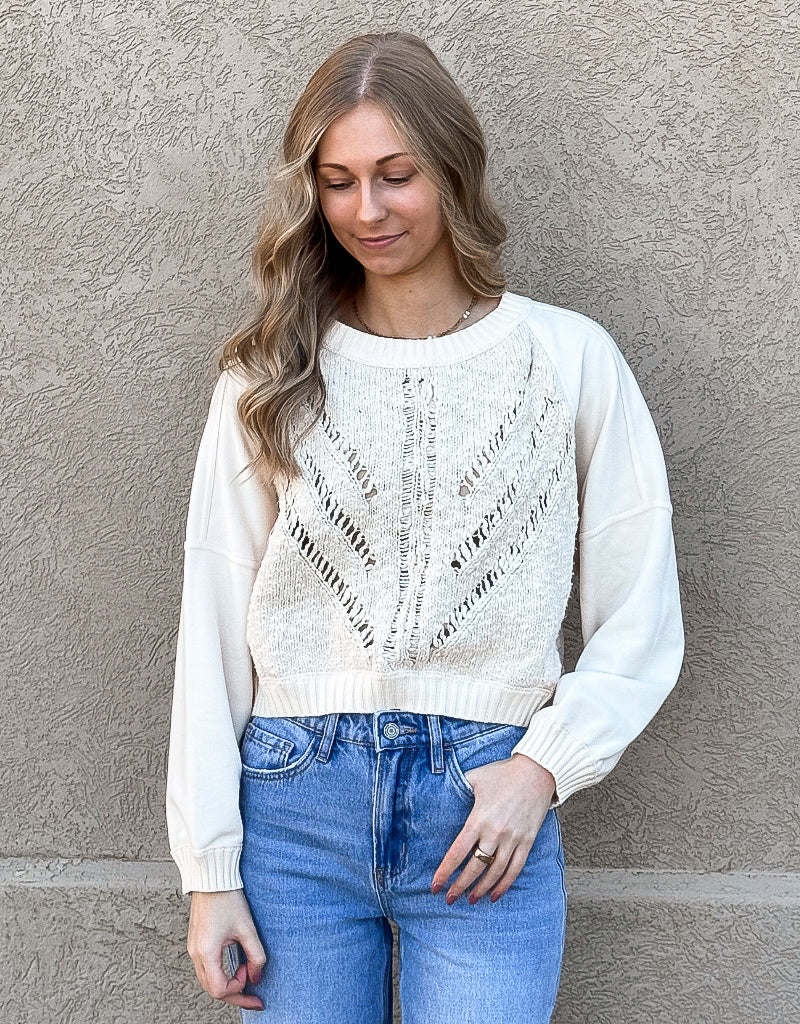 Close-up of the Oatmeal Cable Sweater Front Top featuring a modern crew neck and textured knit pattern.