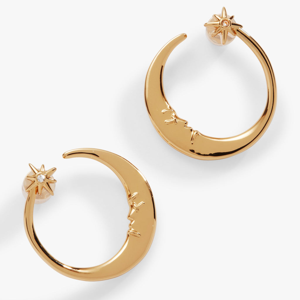Gold-tone crescent moon hoop earrings featuring a small crystal star and vintage face detail
