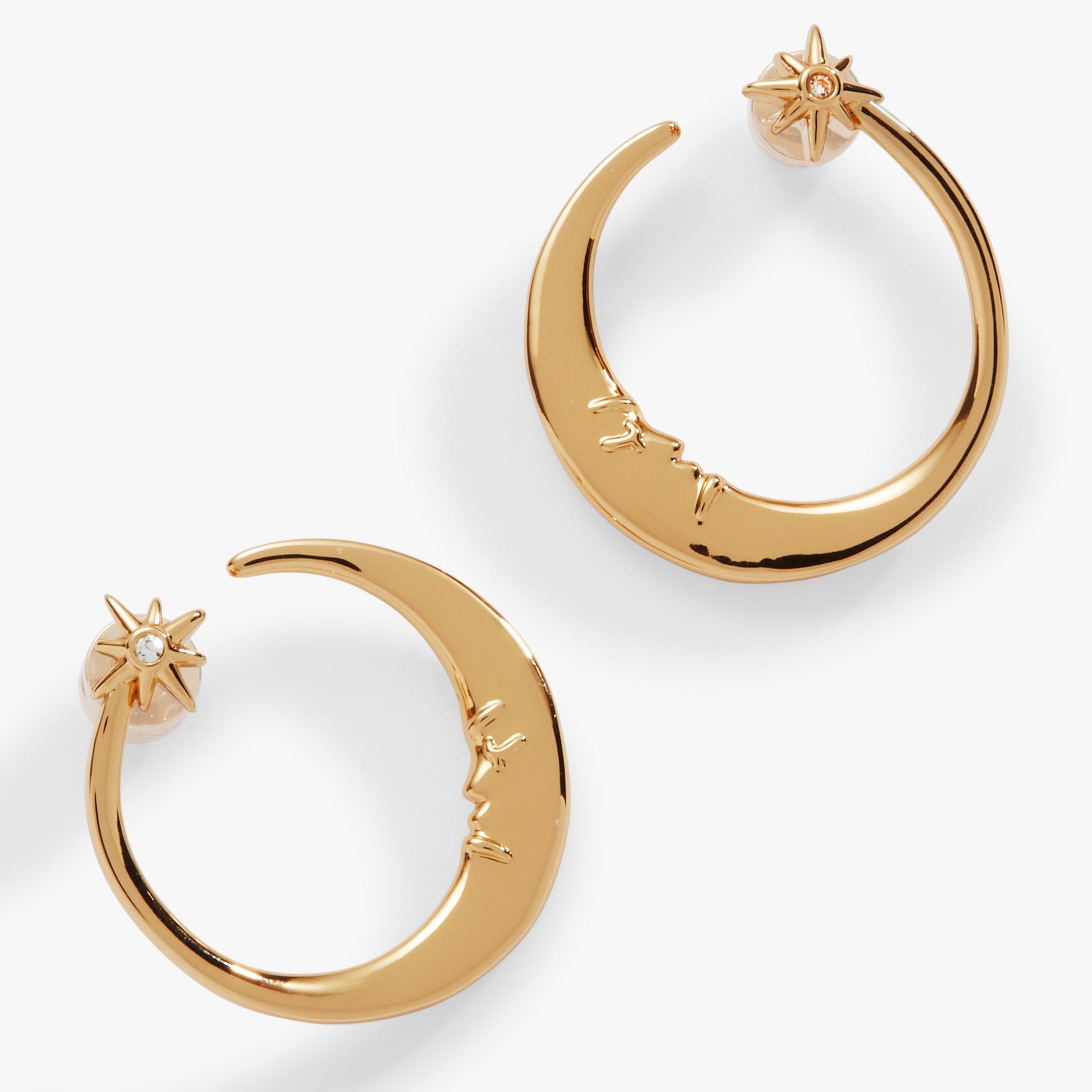 Gold-tone crescent moon hoop earrings featuring a small crystal star and vintage face detail