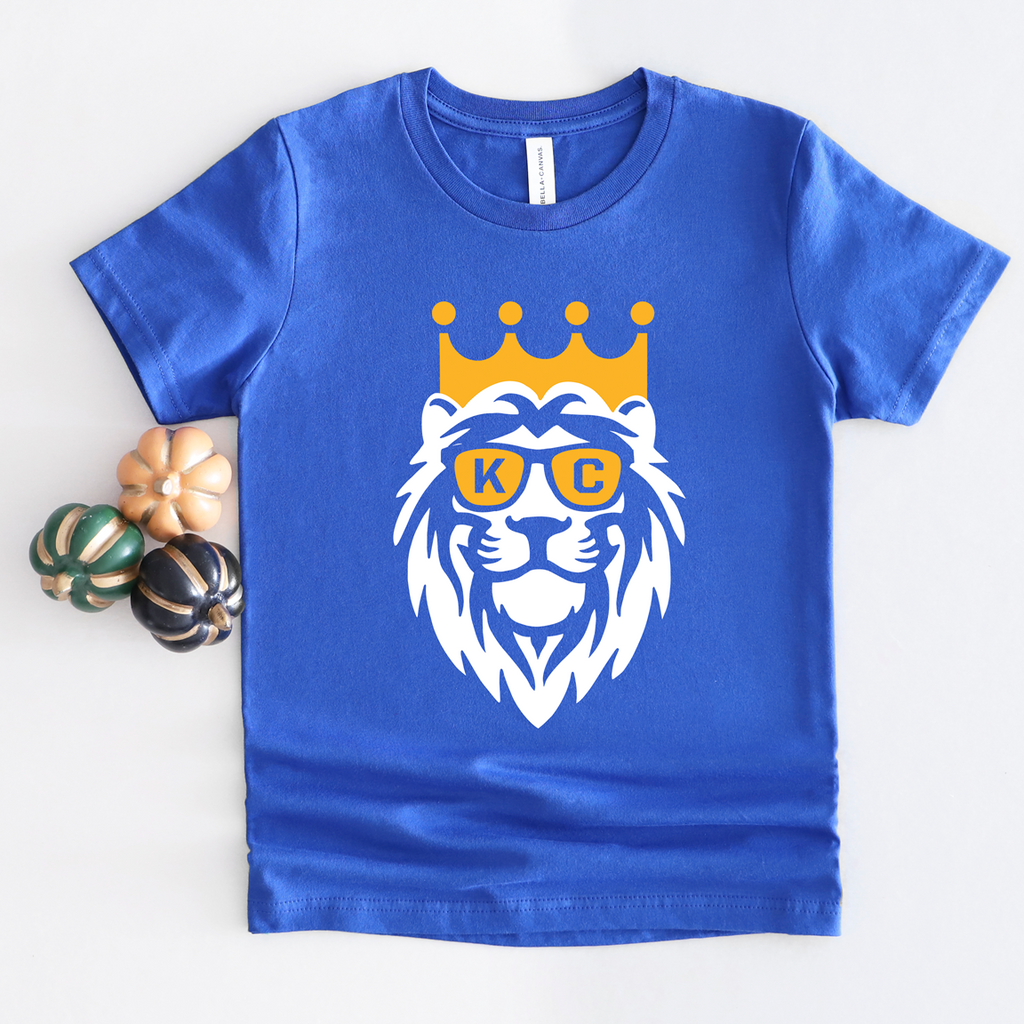 Youth short sleeve t-shirt in heather true royal blue featuring a white and gold crown lion graphic with glasses.