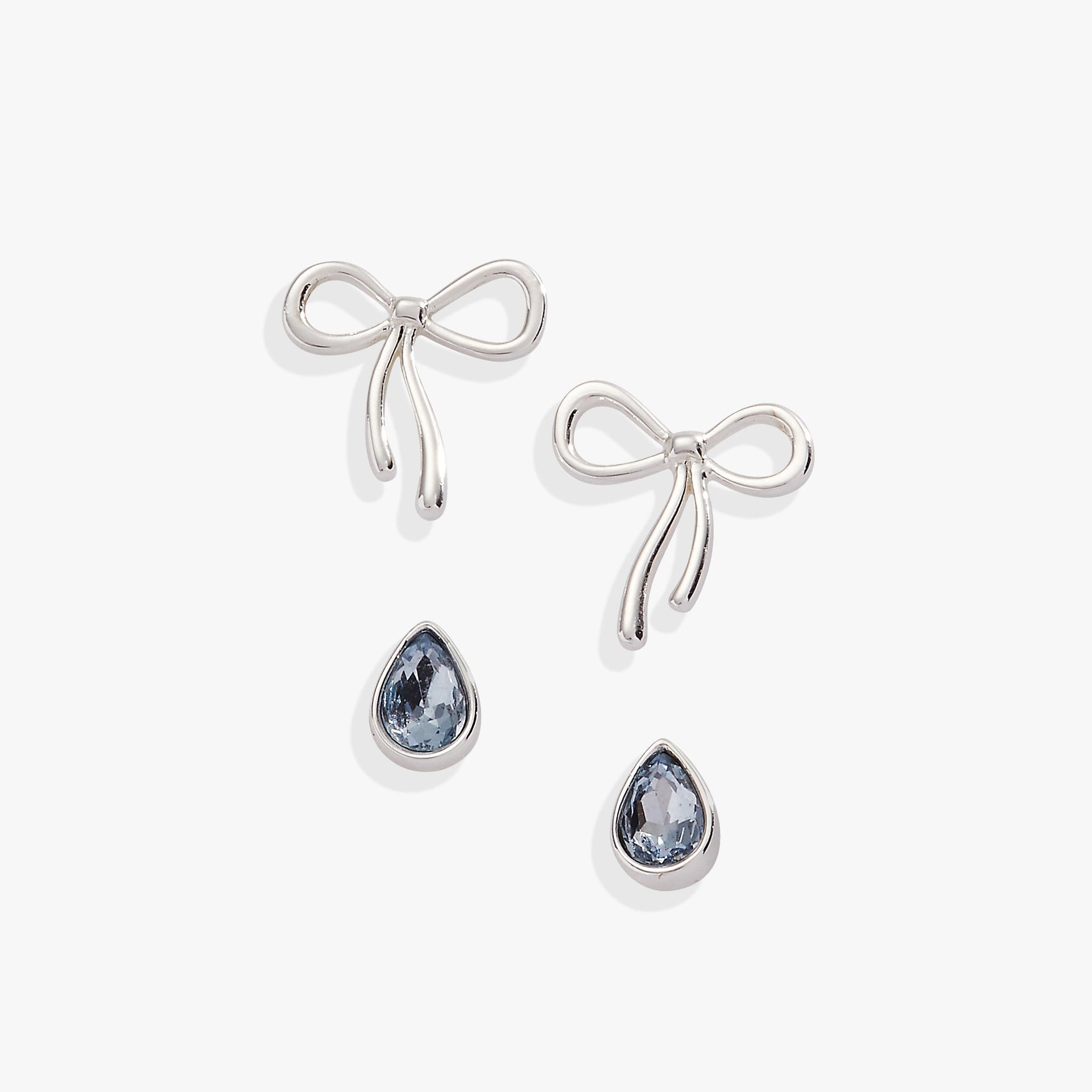 A set of Bow & Teardrop stud earrings in silver, gold, and blue finish against a neutral background.