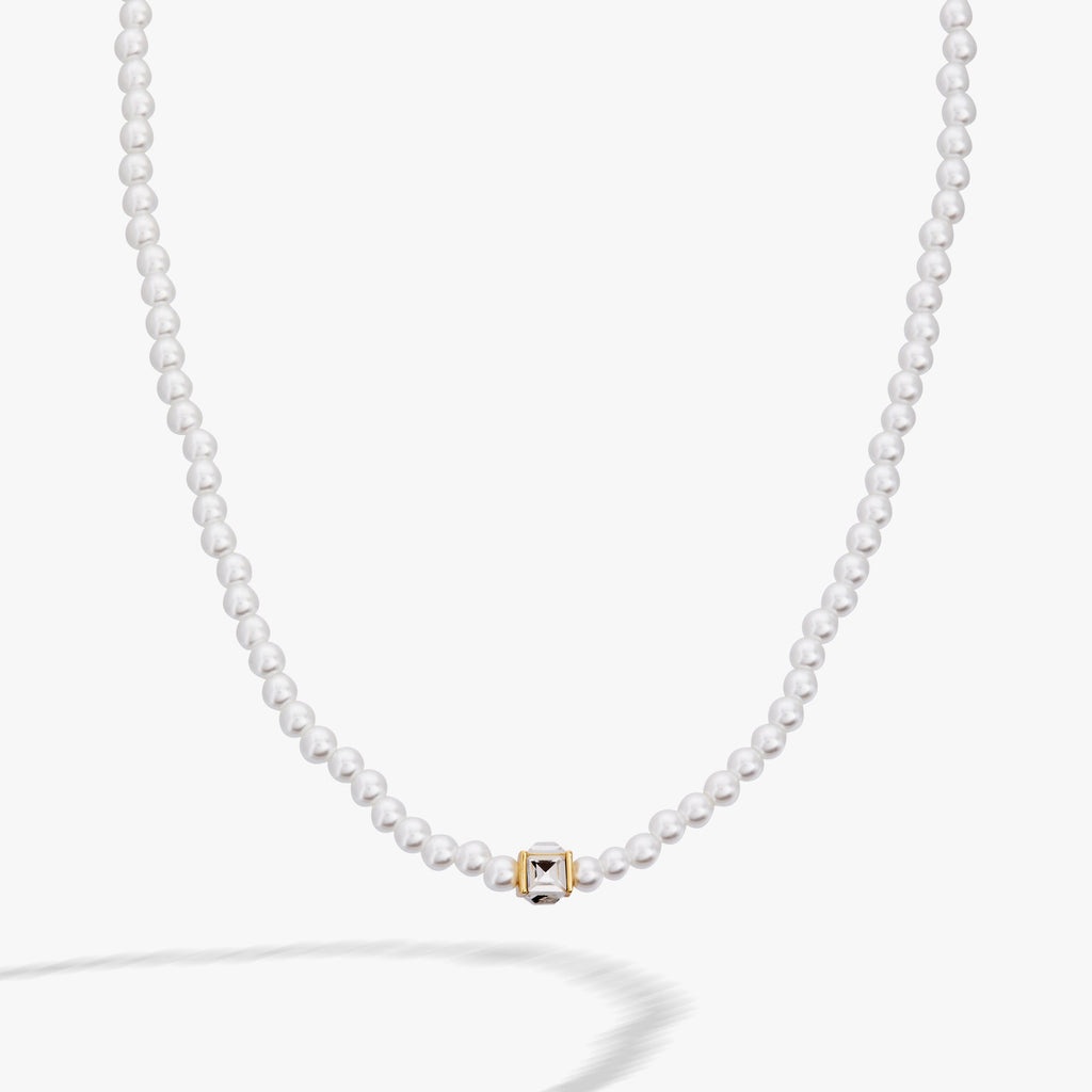 Crystal and white faux pearl beaded necklace with a clear square cube charm and gold accents