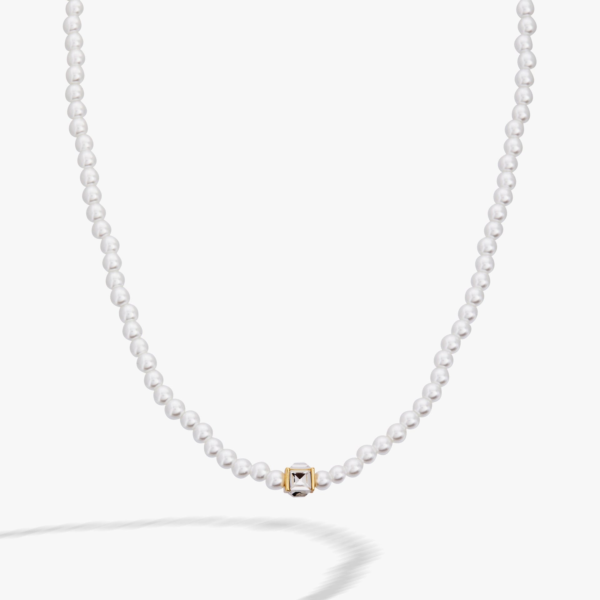 Crystal and white faux pearl beaded necklace with a clear square cube charm and gold accents
