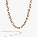 Gold chunky curb chain necklace with pave crystal accents styled for modern glamour