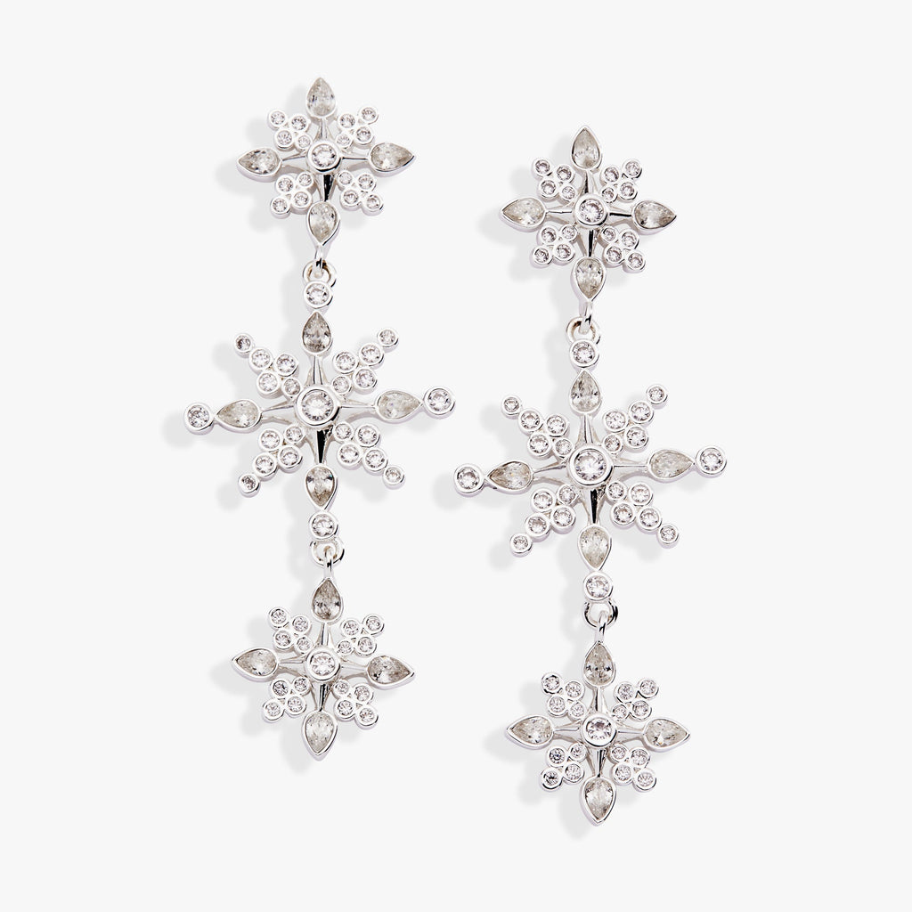 Crystal snowflake linear drop earrings in silver with clear round and pear-cut crystal accents.
