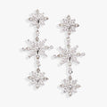 Crystal snowflake linear drop earrings in silver with clear round and pear-cut crystal accents.