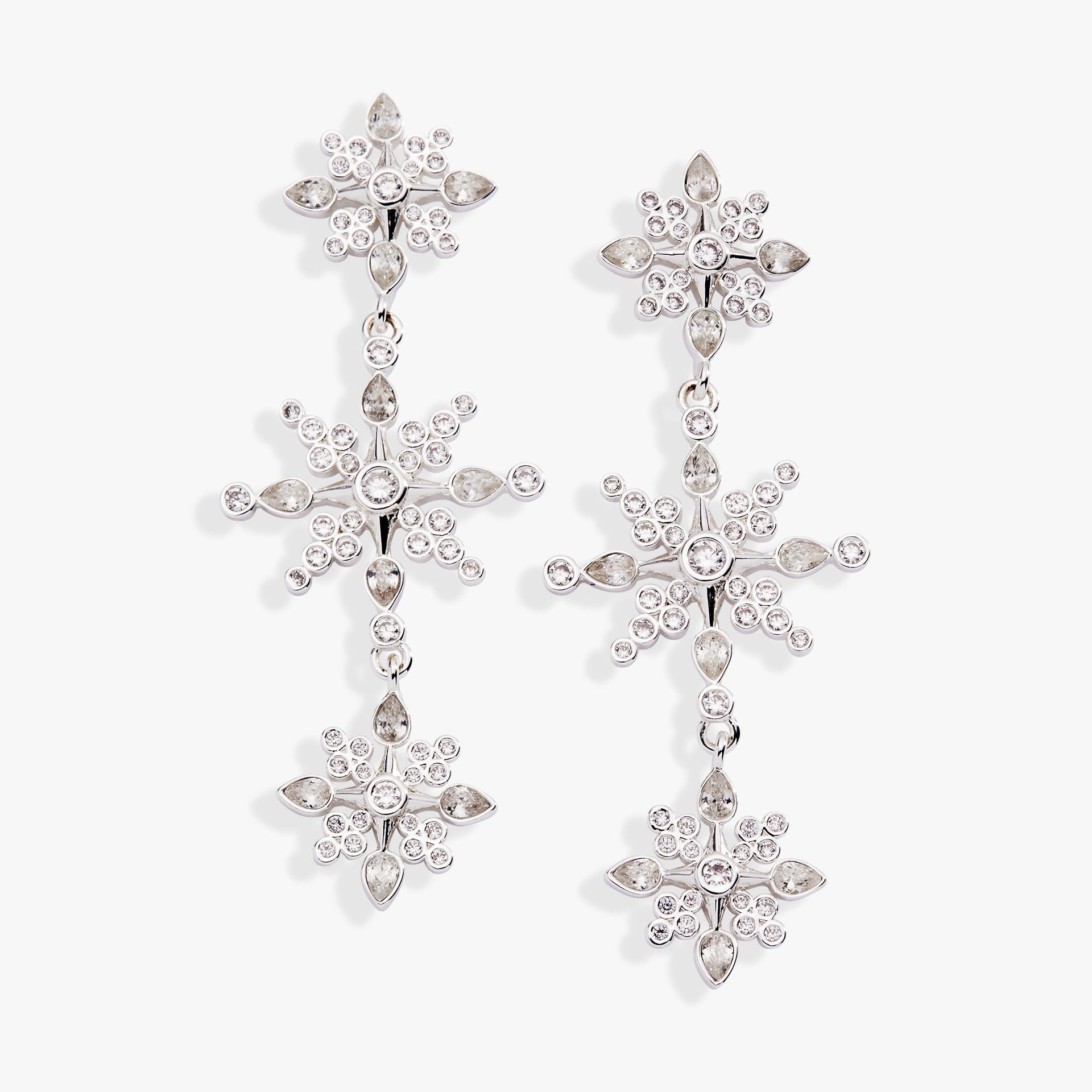 Crystal snowflake linear drop earrings in silver with clear round and pear-cut crystal accents.