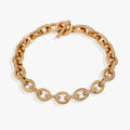 Close-up of a delicate oval link toggle bracelet paved with sparkling crystals.
