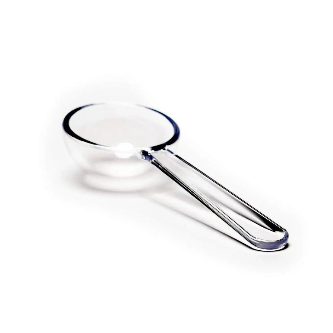 A clear, BPA-free plastic tea measuring scoop on a white background