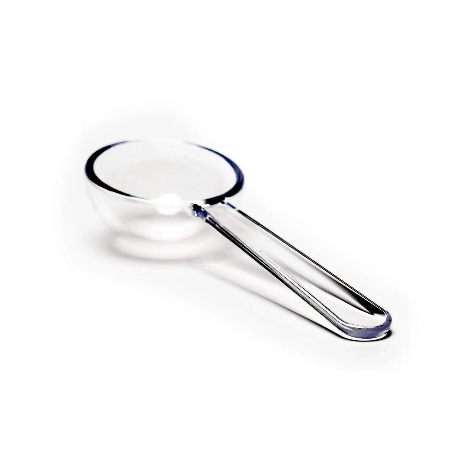 A clear, BPA-free plastic tea measuring scoop on a white background