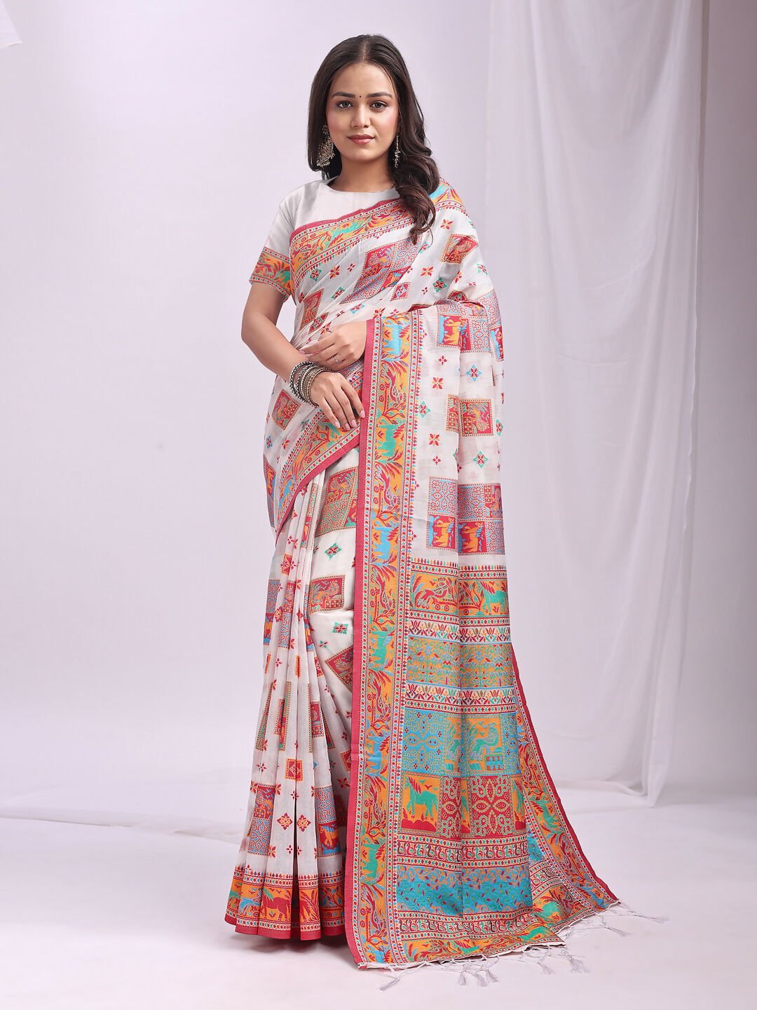 A white linen cotton saree with matching blouse piece draped elegantly, showcasing its fine fabric texture.