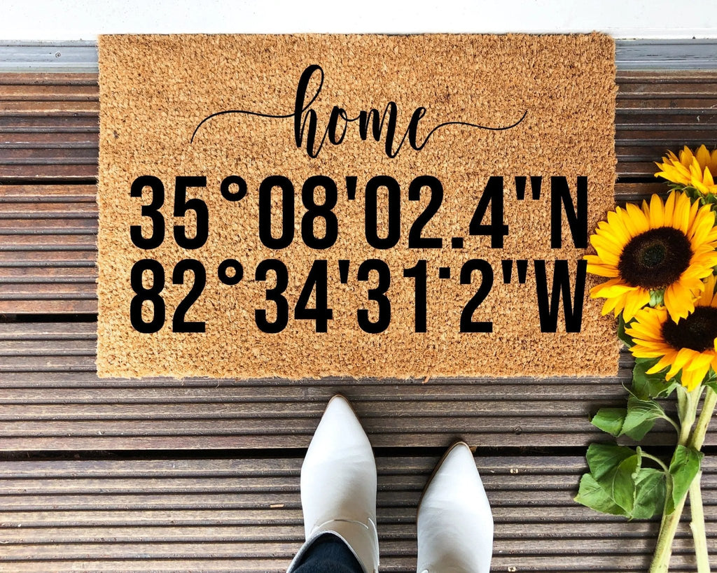 Customized brown and black coordinate doormat on a neutral porch entryway