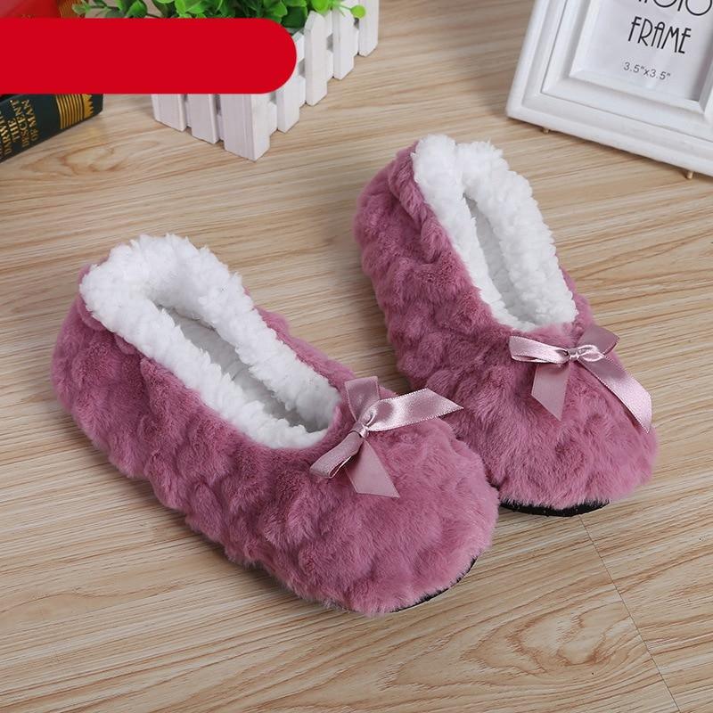 A pair of cozy, soft plush indoor slippers with fleece lining and non-slip soles.