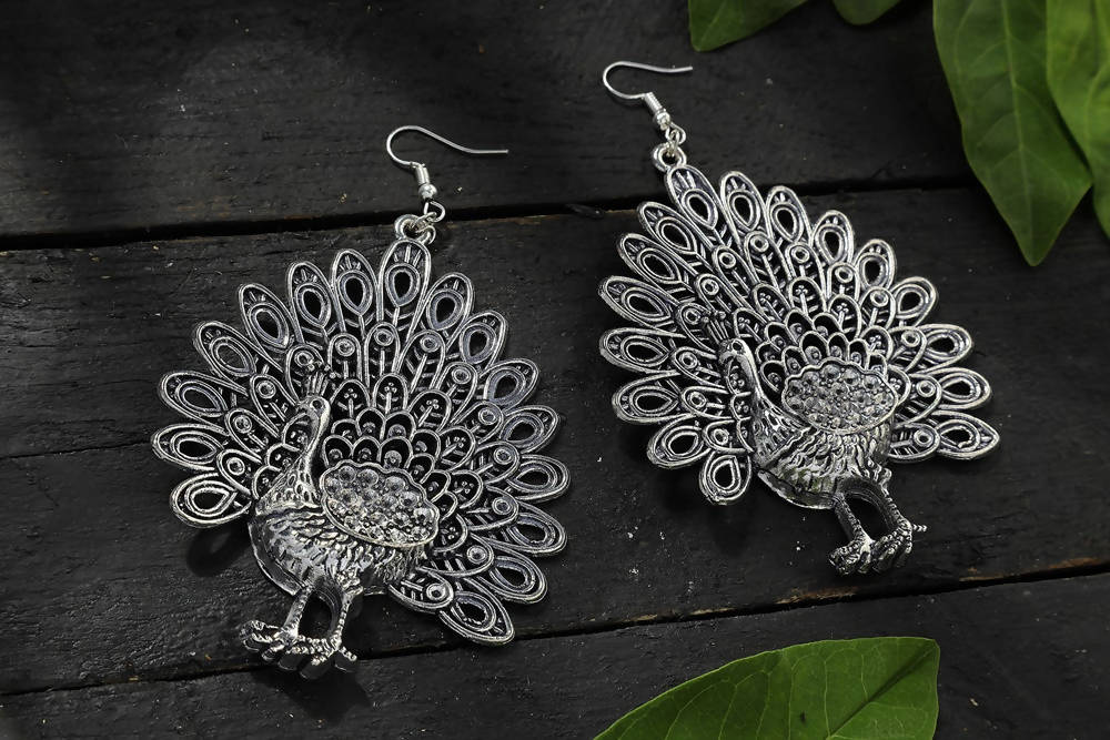 Oxidised silver-toned peacock motif earrings for traditional and ethnic wear