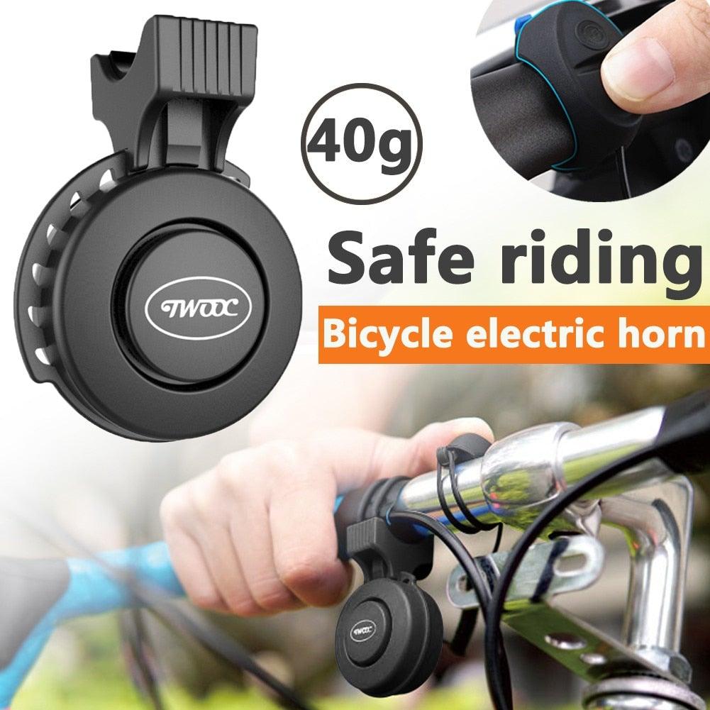 Minimalist black USB rechargeable electronic bike horn mounted on a bicycle handlebar