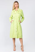 Woman wearing a vibrant lime green distressed denim button-up shirt dress