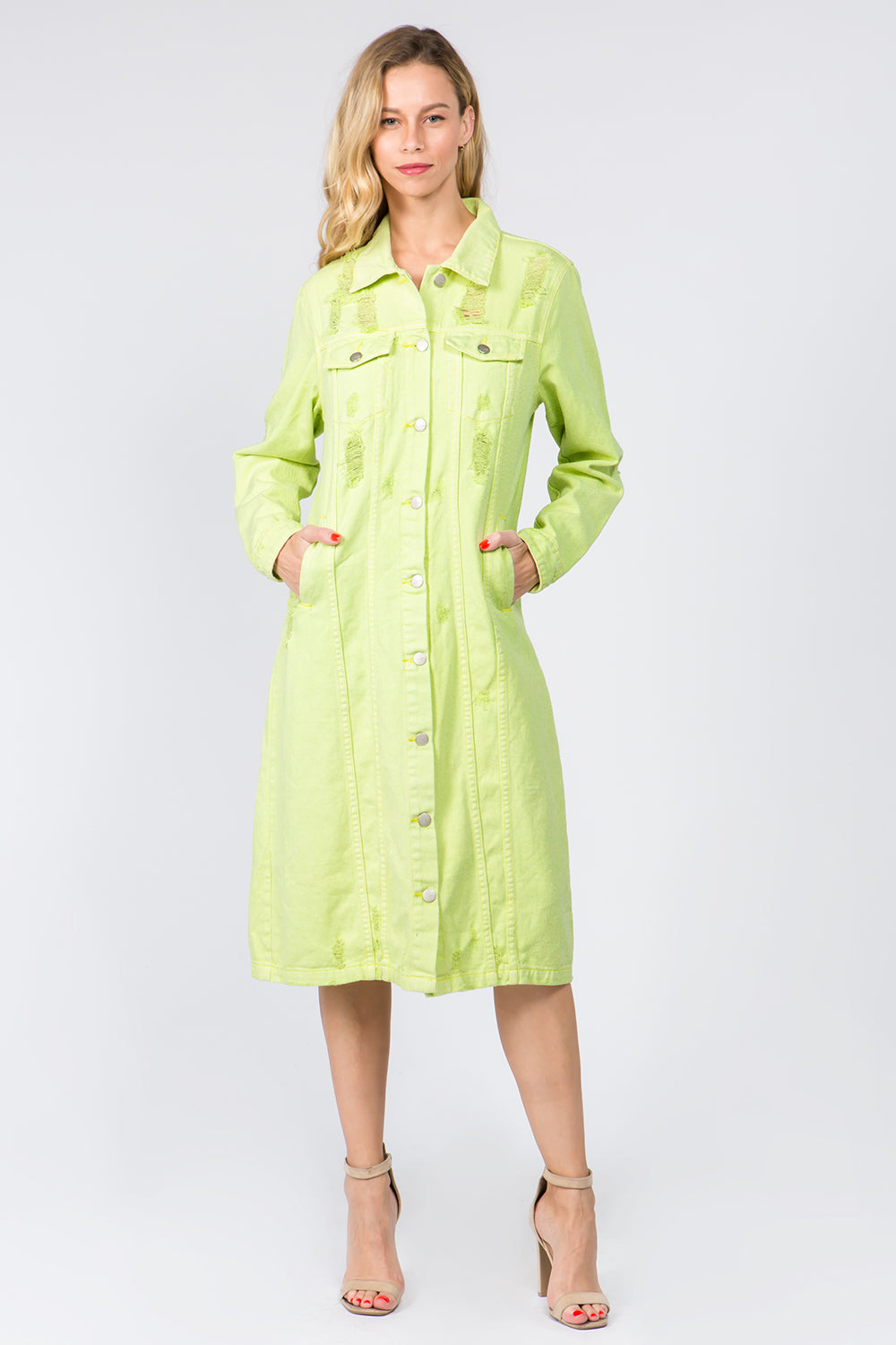 Woman wearing a vibrant lime green distressed denim button-up shirt dress