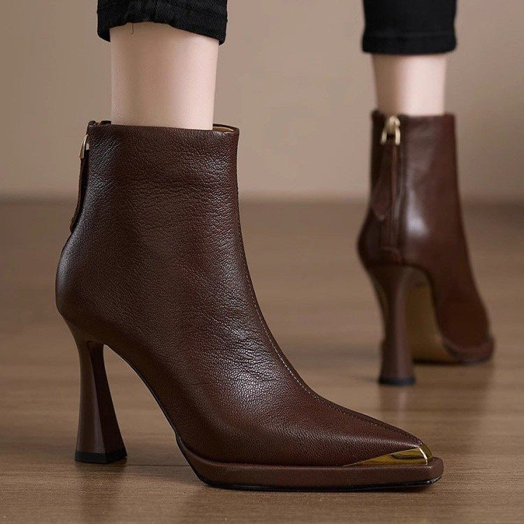 Brown pointed-toe ankle boots with gold metal tip and flared heel shown from the side
