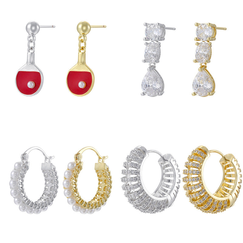 French-style teardrop earrings with a pear-cut crystal in a polished gold and silver tone finish.