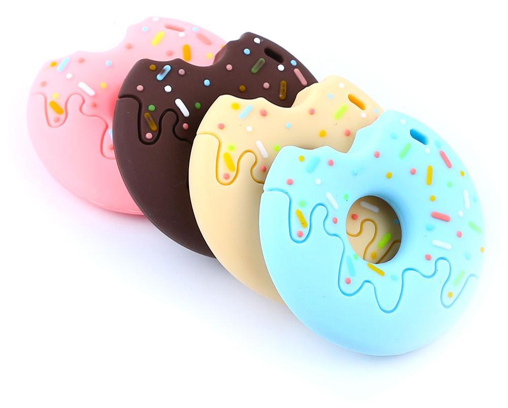 Playful Gingerbread Man Raccoon silicone teething toy in pastel colors for modern nursery decor