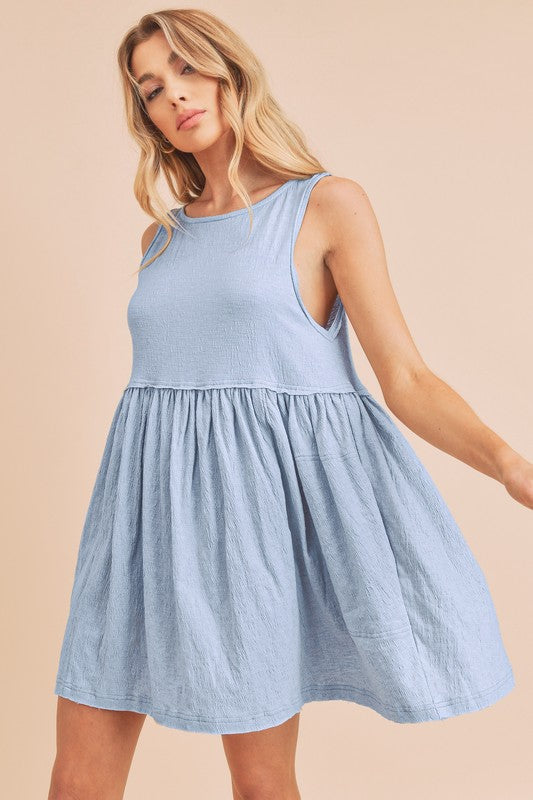 Light blue cotton mini tank dress with a bohemian flutter design.