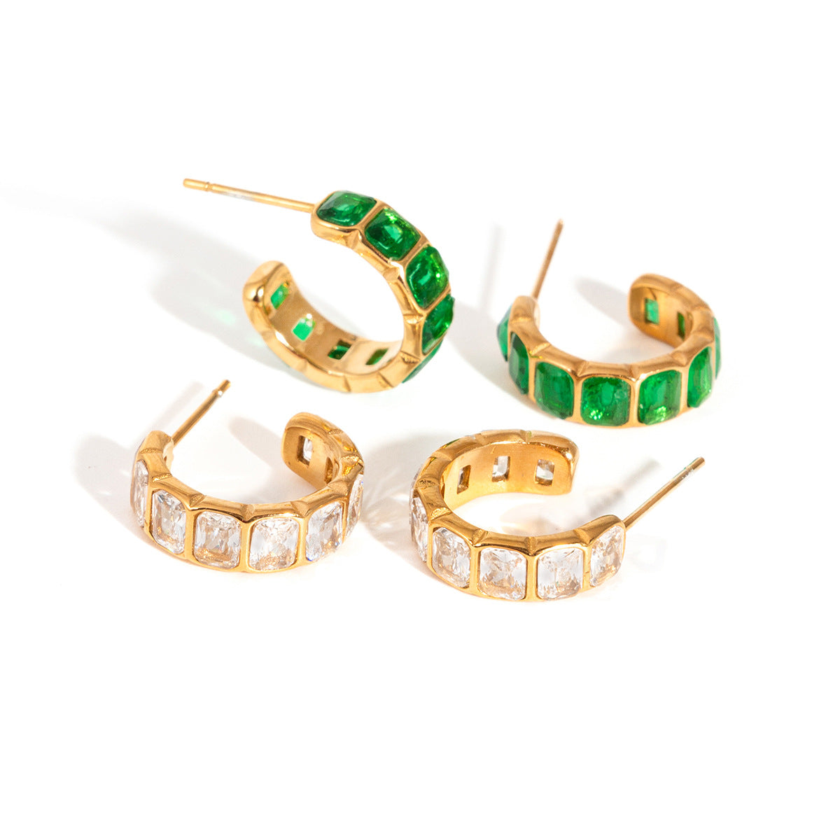 Close-up of polished Green Zircon Hoop Earrings with delicate tassel drops in stainless steel