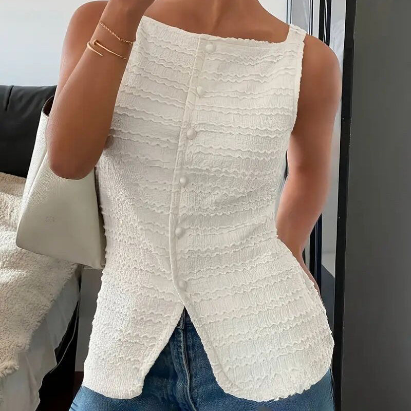 A woman wearing a white textured square neck button-up vest top with blue jeans