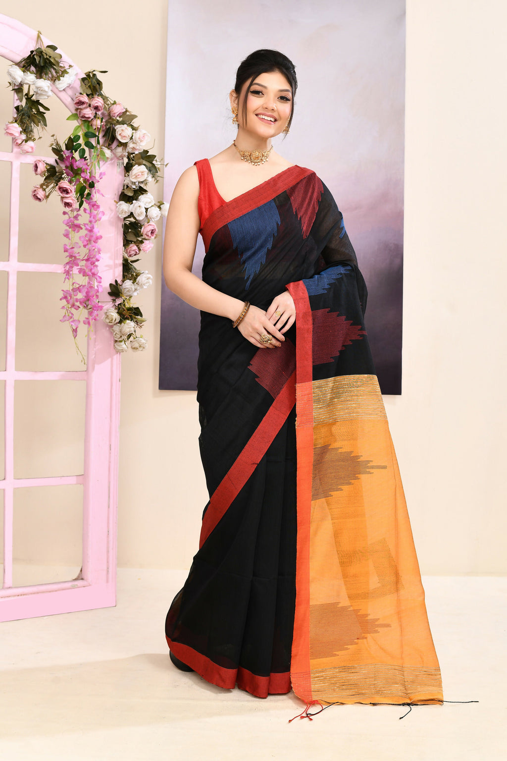 Black Jamdani saree with traditional gold temple border and elegant embellishments