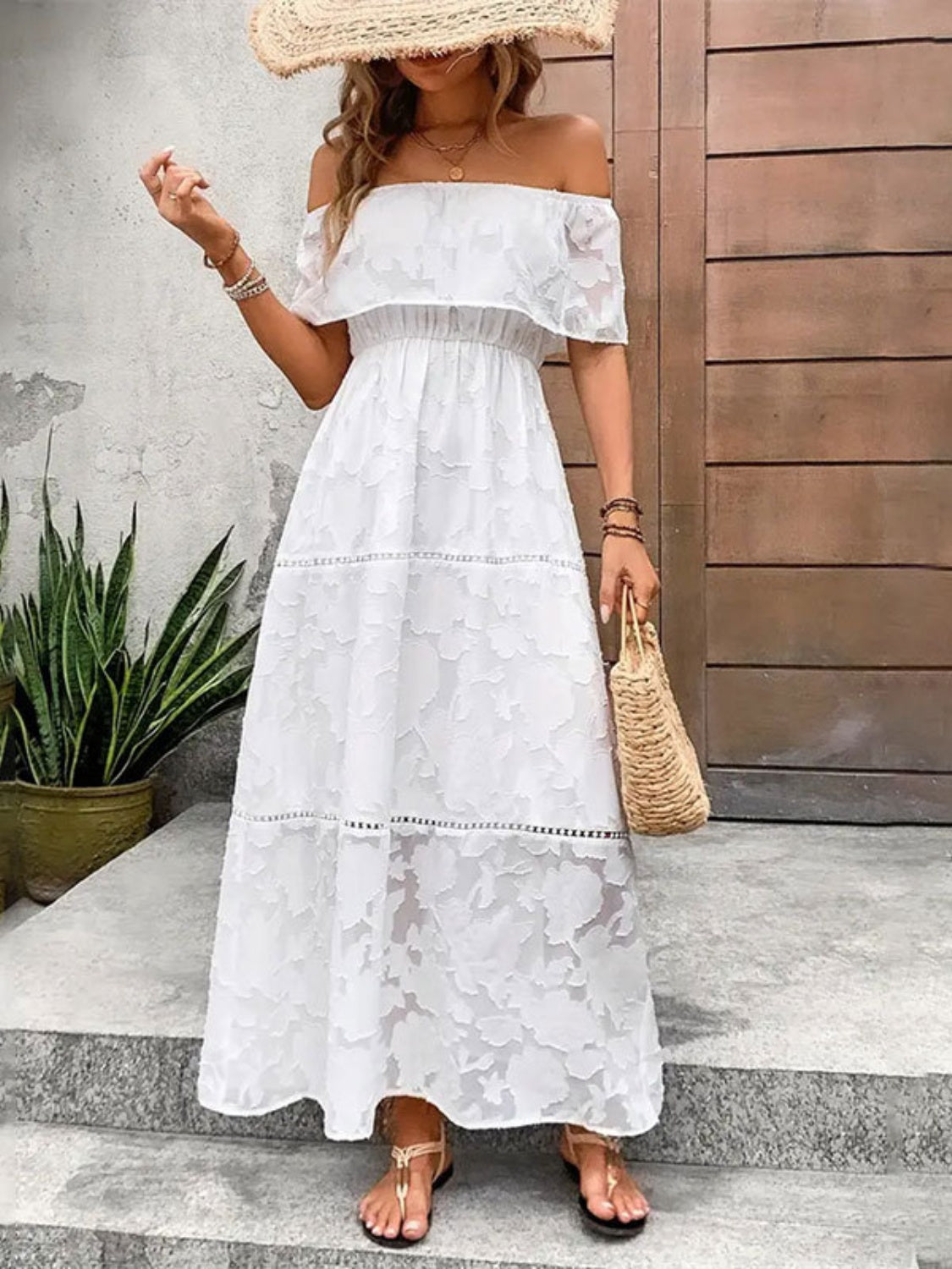 A white floral off-shoulder maxi dress with a flowy silhouette perfect for summer resort wear