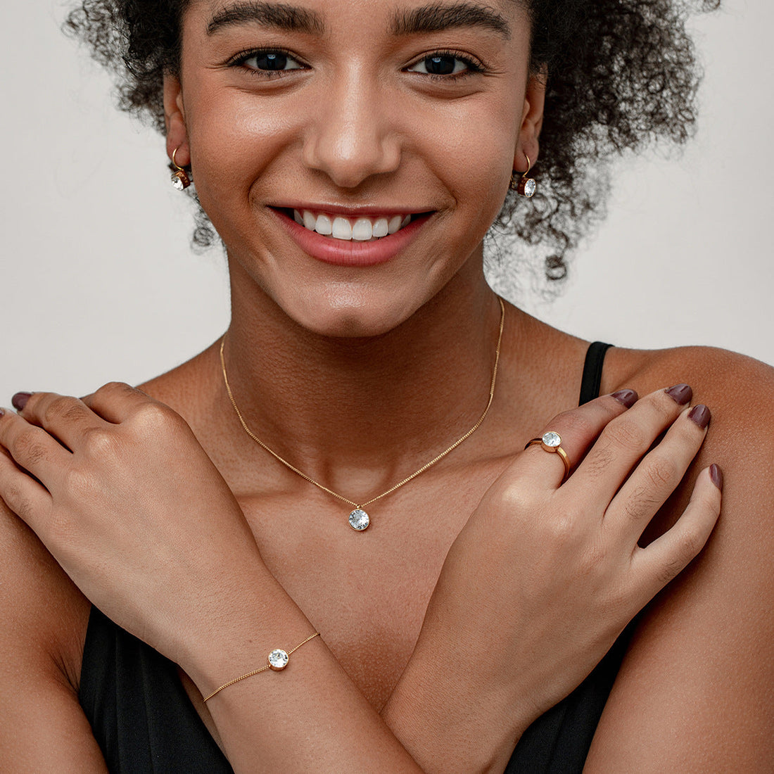 Minimalist gold-plated ring featuring a round bezel-set mint green crystal on a polished gold band.