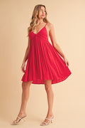 A vibrant red ruched mini cami dress with a deep plunging neckline
