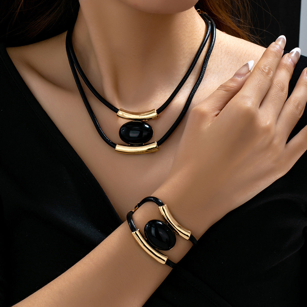 Multilayer vintage necklace and matching bracelet set with oval and circle acrylic accents.