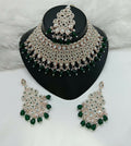 Dista women's brass necklace set with vibrant green stone work and matching earrings and tikka