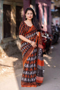 Bright orange linen blend saree with ethnic motifs and matching unstitched blouse