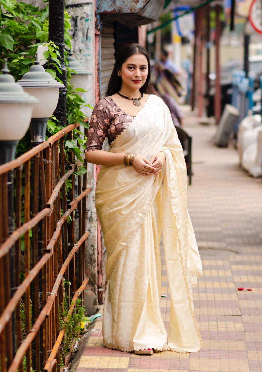 Cream poly silk saree with ethnic mango woven motifs and fancy cutwork border