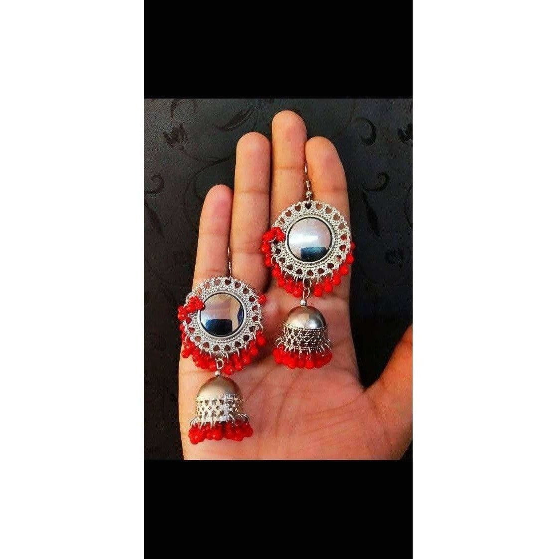 Bright orange earrings with intricate mirror work design