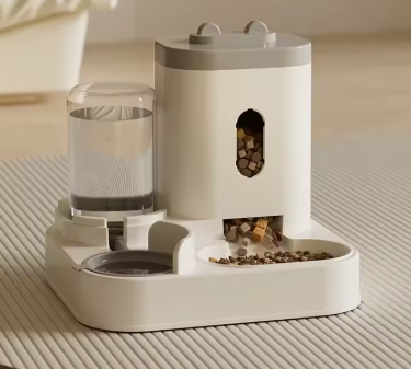 Modern grey automatic pet feeder and water dispenser in a minimalist kitchen setting