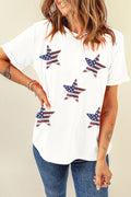 A woman wearing a white short-sleeve t-shirt with five patriotic sequin star patches in red, white, and blue, styled with jeans.