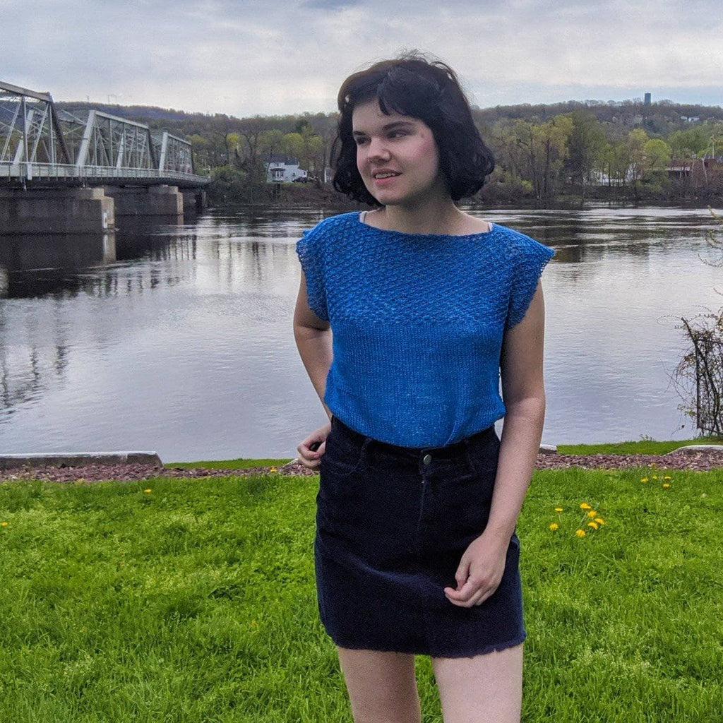 A finished Daisy Stitch Short Sleeve Top featuring a delicate lacy yoke design displayed on a flat surface.