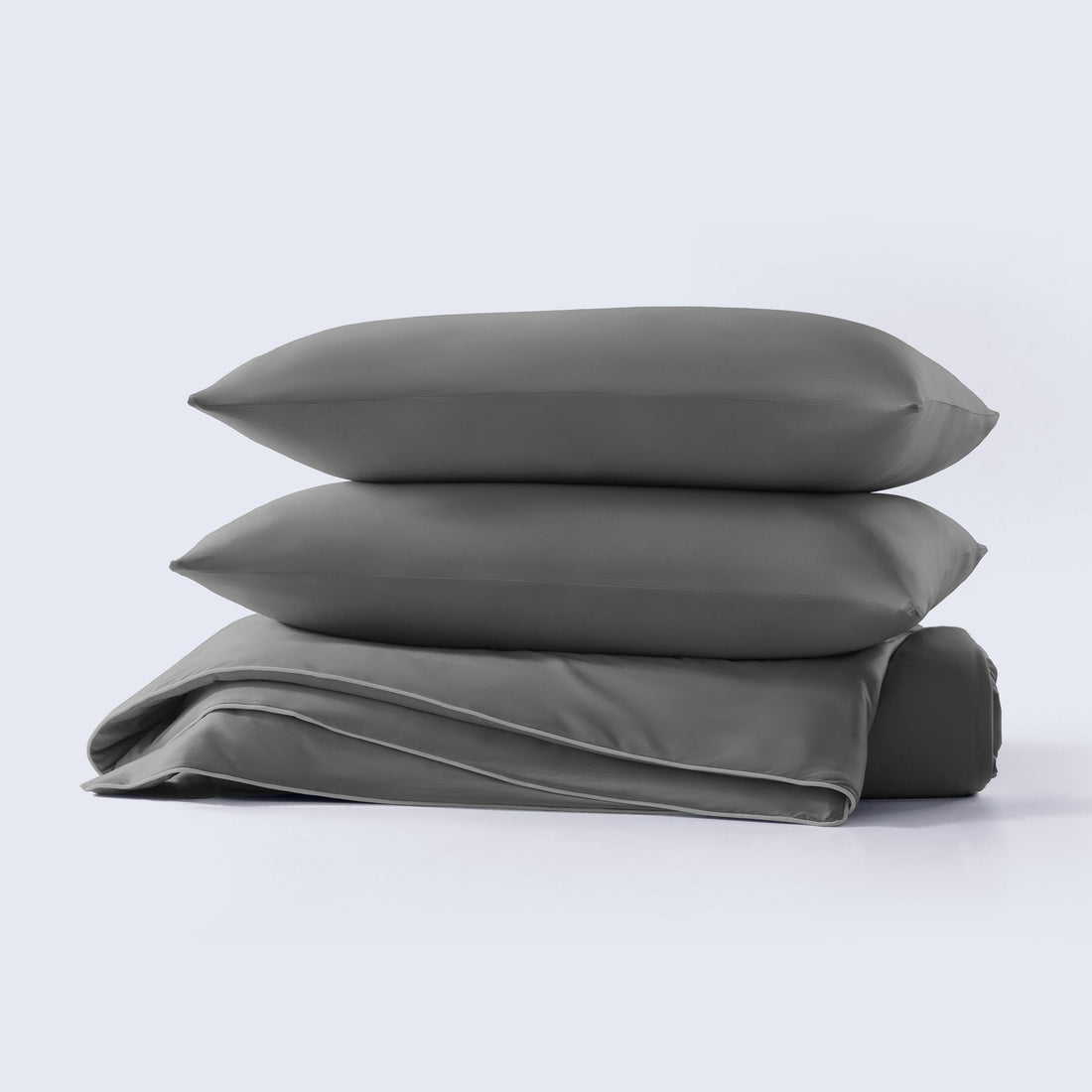 A grey cooling comforter set with matching pillows presented on a neutral background.