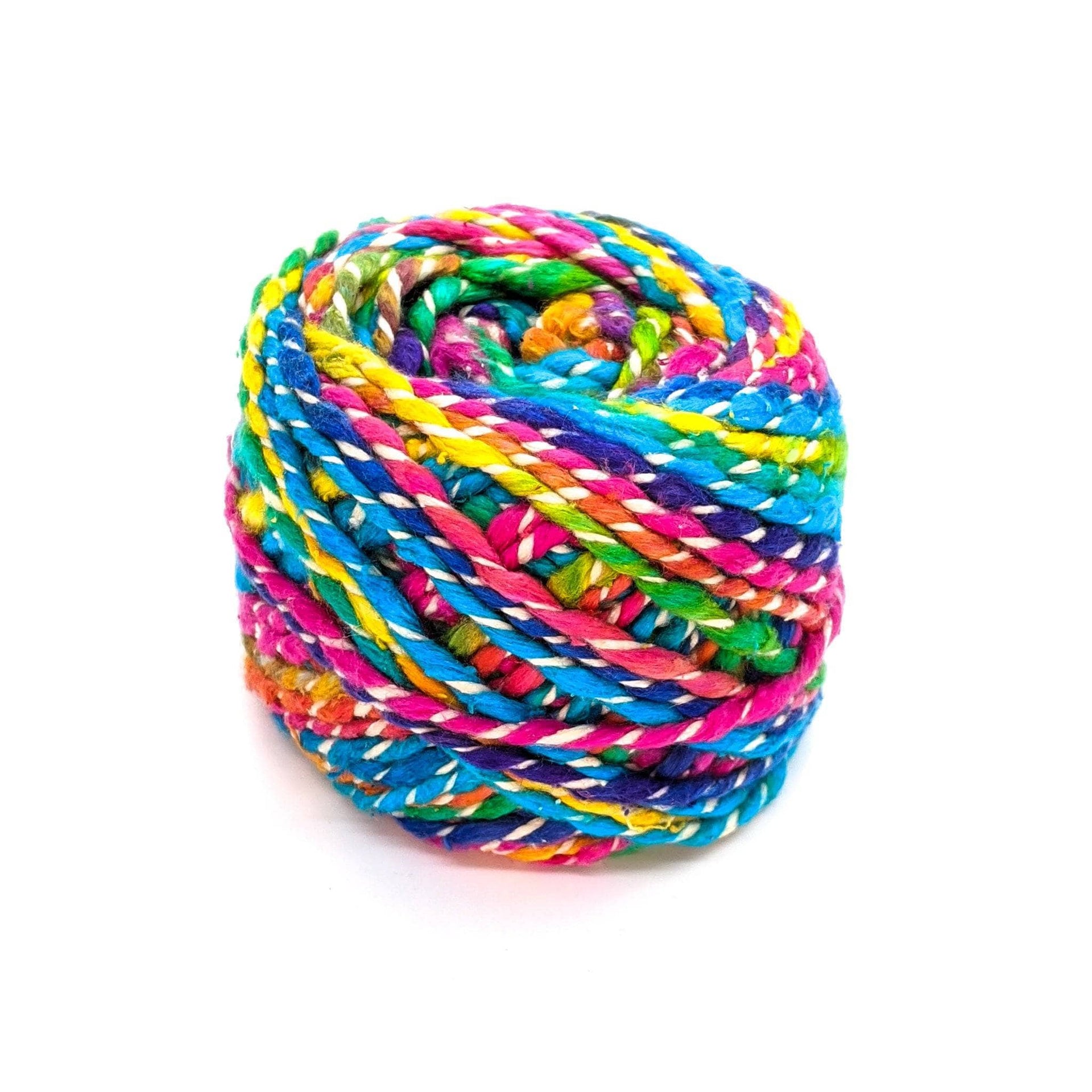 Vibrant rainbow multi-color Fancy Twist silk yarn with white accents in a worsted weight texture.