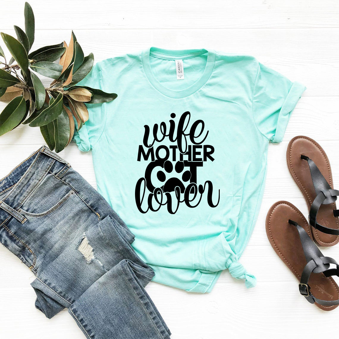 Mint green graphic t-shirt with black text reading Wife Mother Cat Lover
