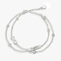 Double strand infinity charm bracelet featuring gold and silver tones with clear crystal accents