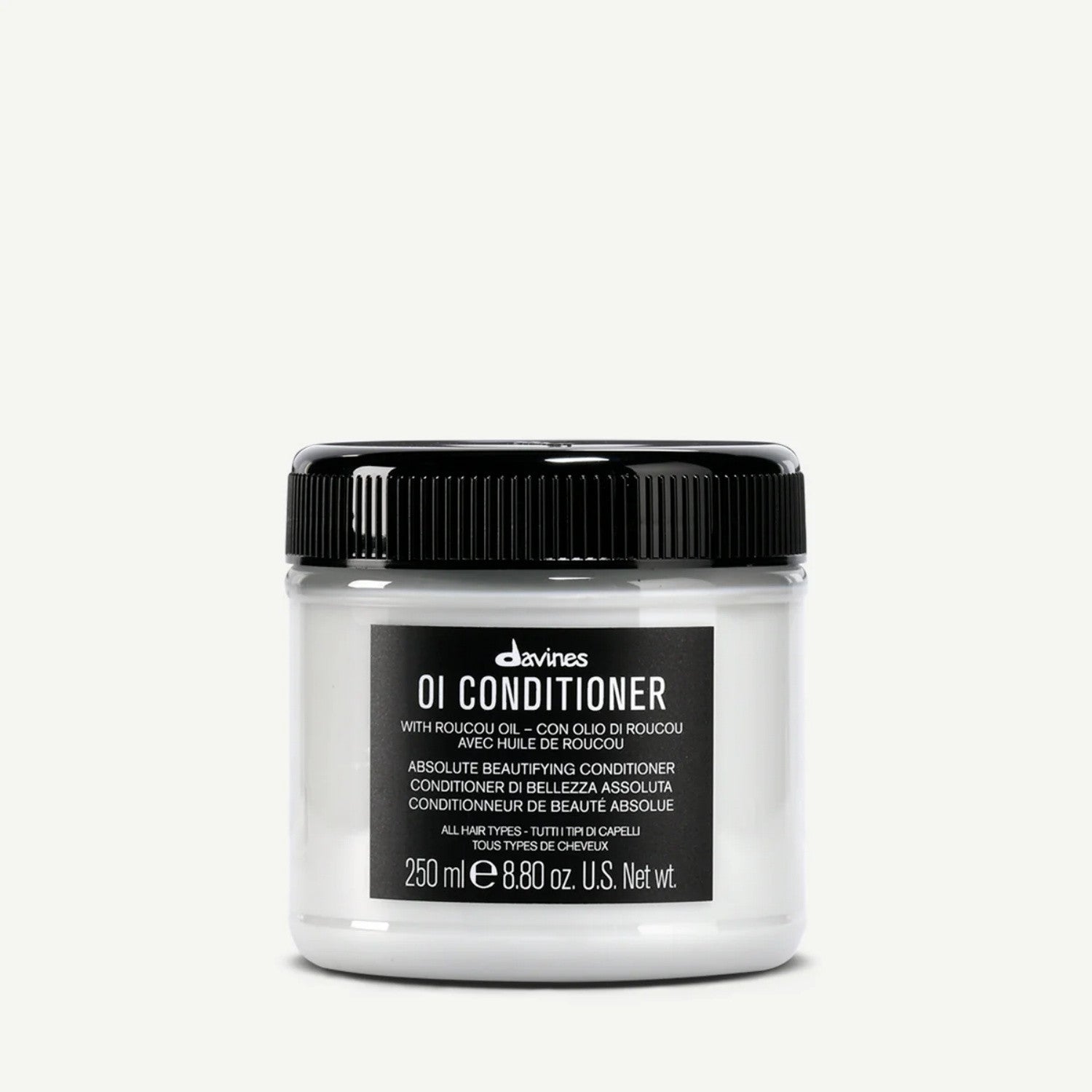 A minimalist jar of Davines OI Absolute Beautifying Conditioner with white and black packaging.