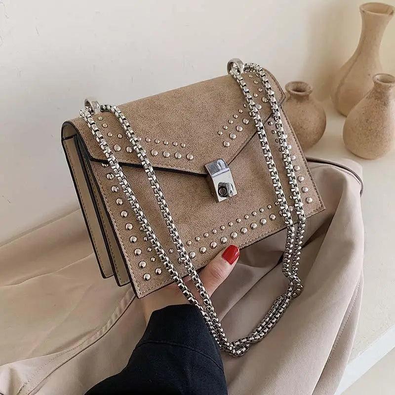Small girls crossbody bag with decorative rivets and chain strap