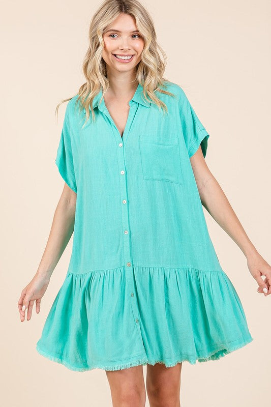 Woman wearing a breathable, soft linen blend button-down mini shirt dress in a casual summer style.