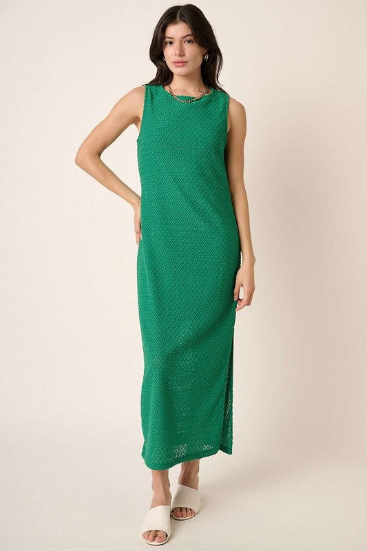 Minimalist green sleeveless knit dress with side slit detail.