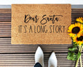 Farmhouse style natural coir doormat with text reading Dear Santa, It's A Long Story on a front porch